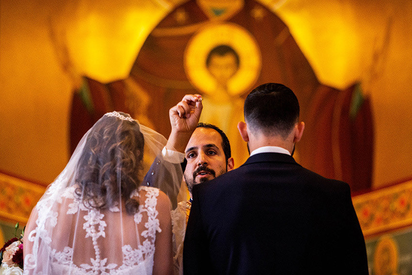 Father blessing the rings at Greek Orthodox Wedding
