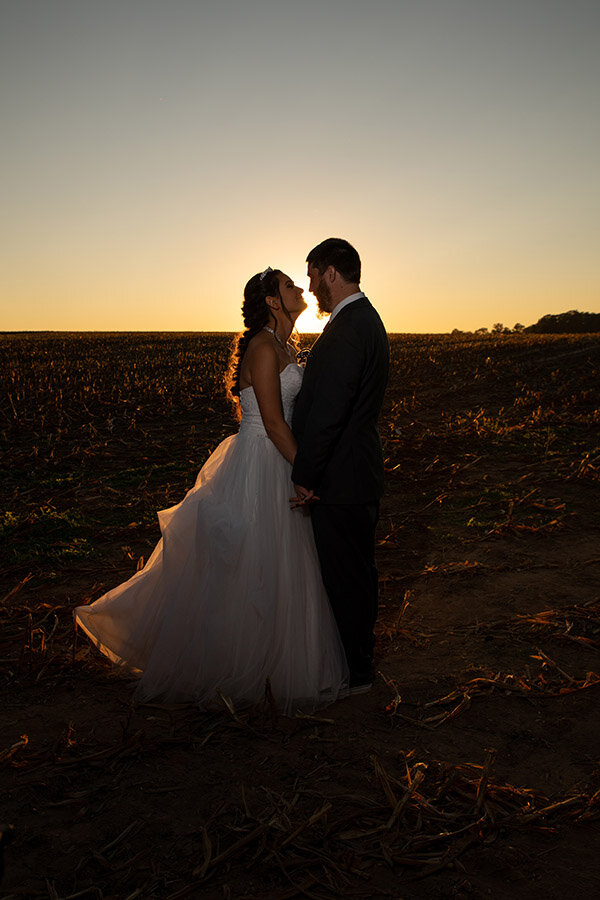 Bride &amp; Groom at Sunset in a field