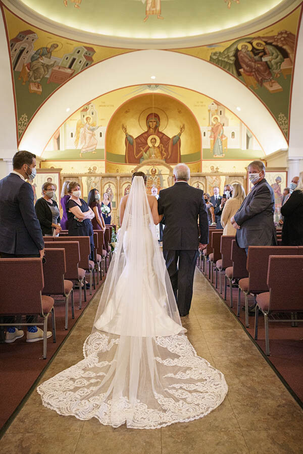Bride's veil walking down the aisle
