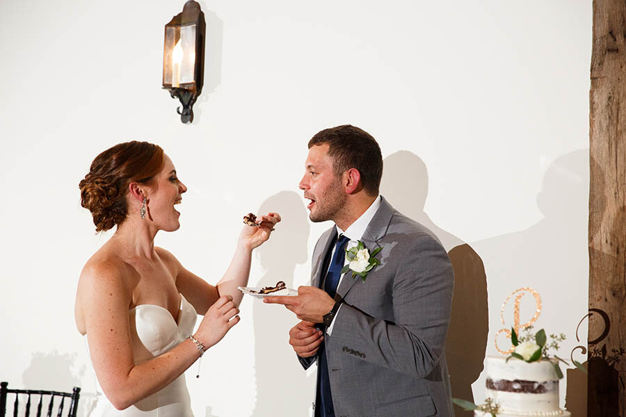 Bride &amp; Groom Feeding each other cake at Riverdale Manor