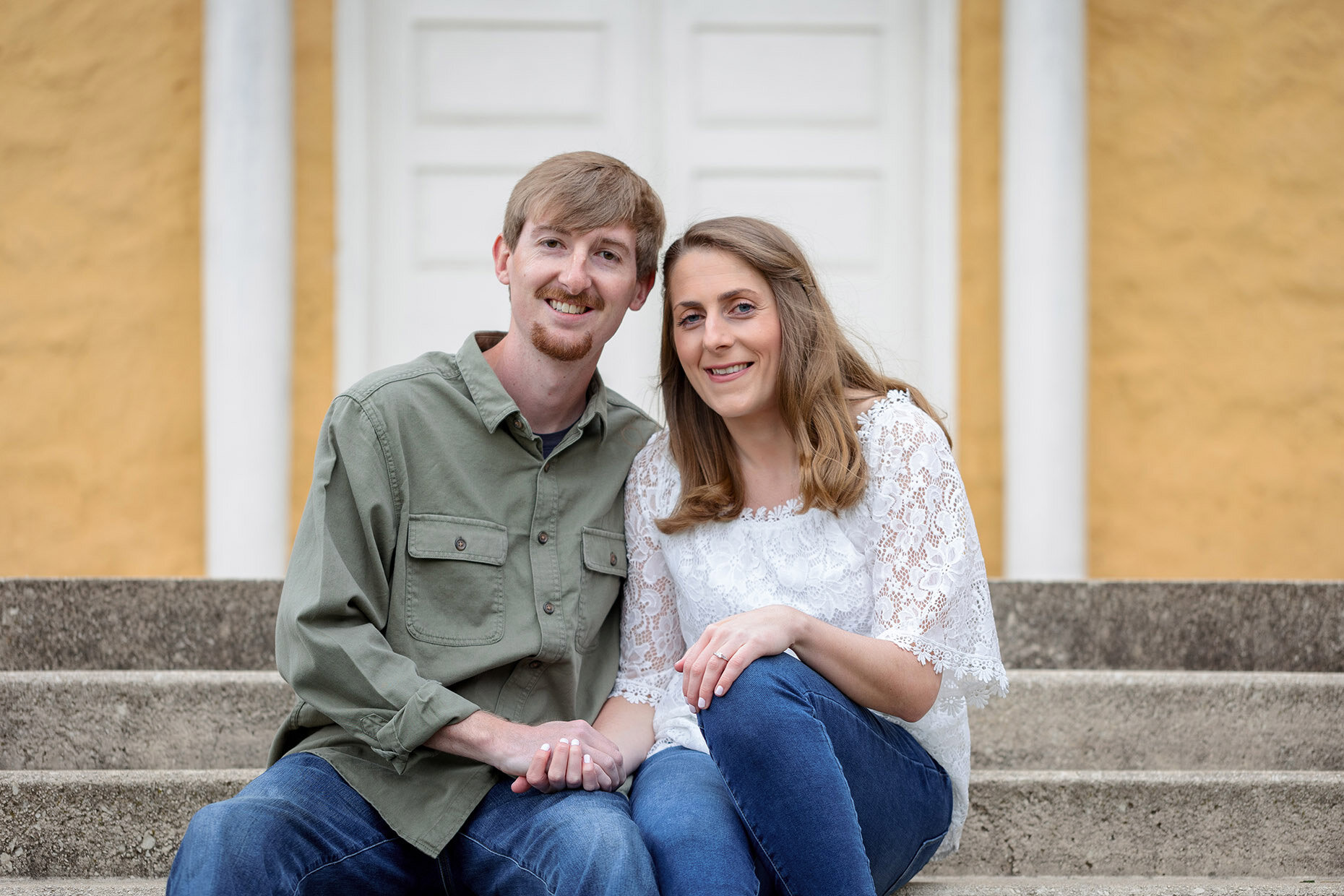 Portrait of couple sitting on steps on Mansion at Hibernia Park