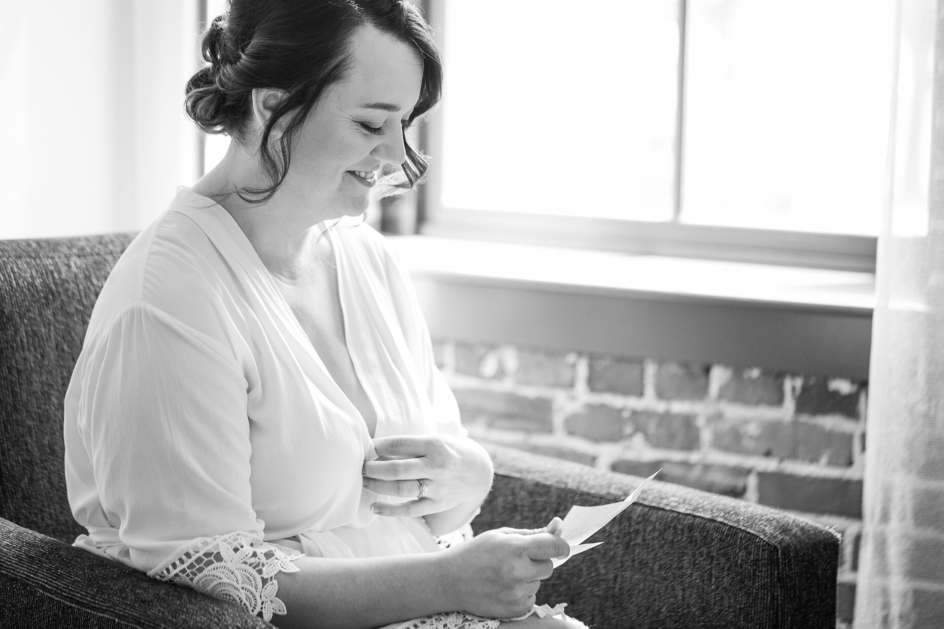 Bride reading note from Groom in Black and White	