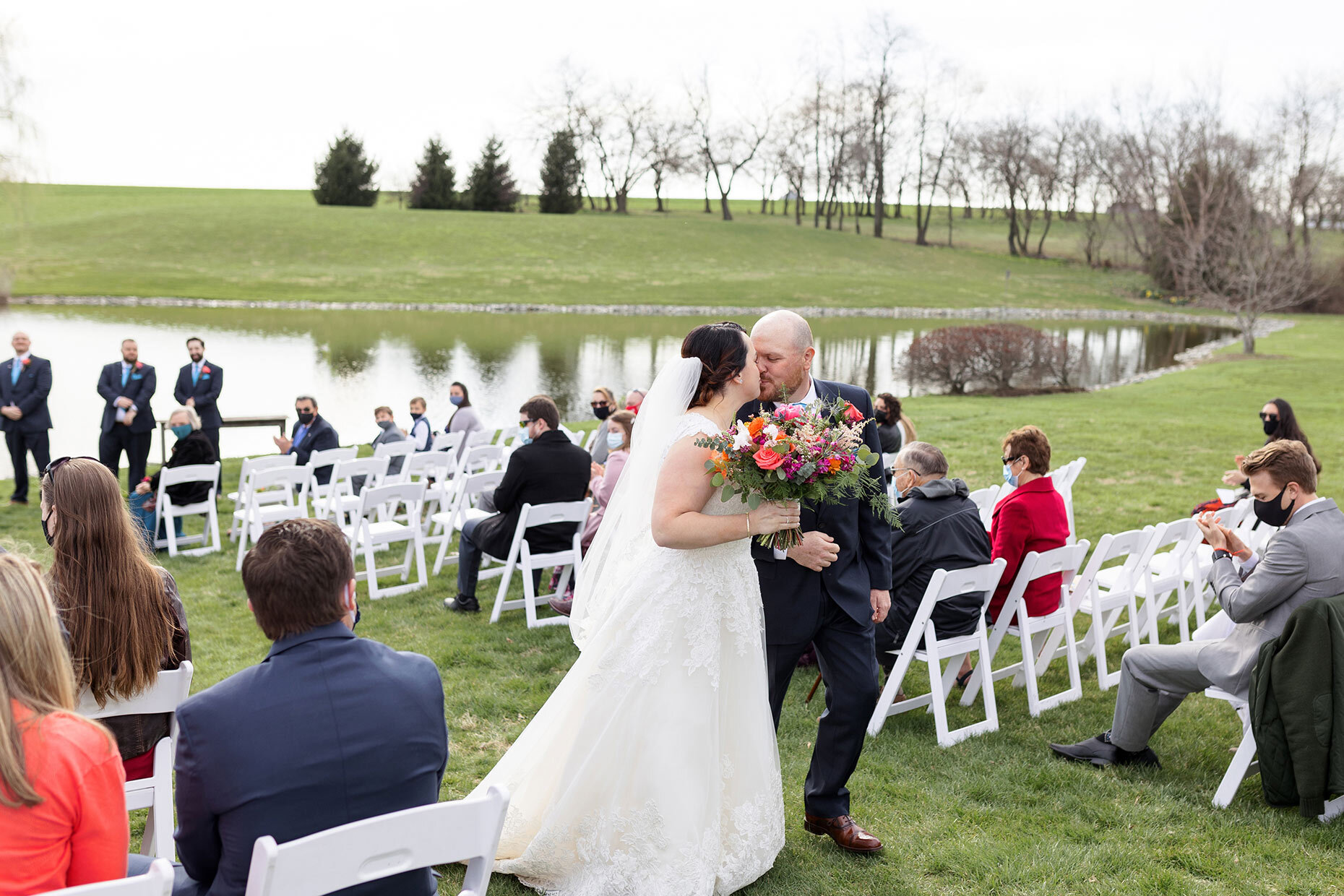 Bride and groom kiss at recessional at Lakefield Weddings, Manheim, PA 