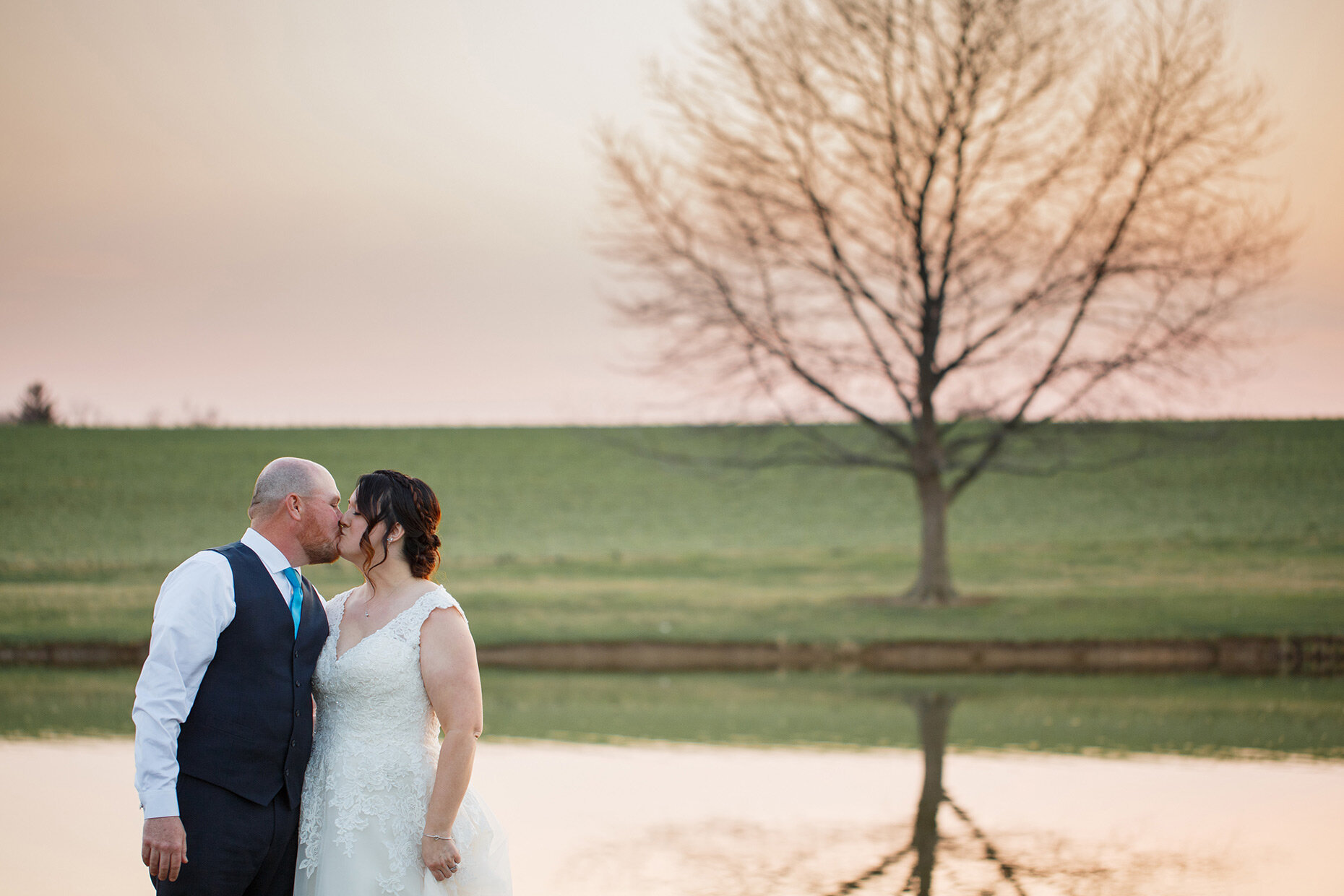 Bride and groom kiss at golden hour