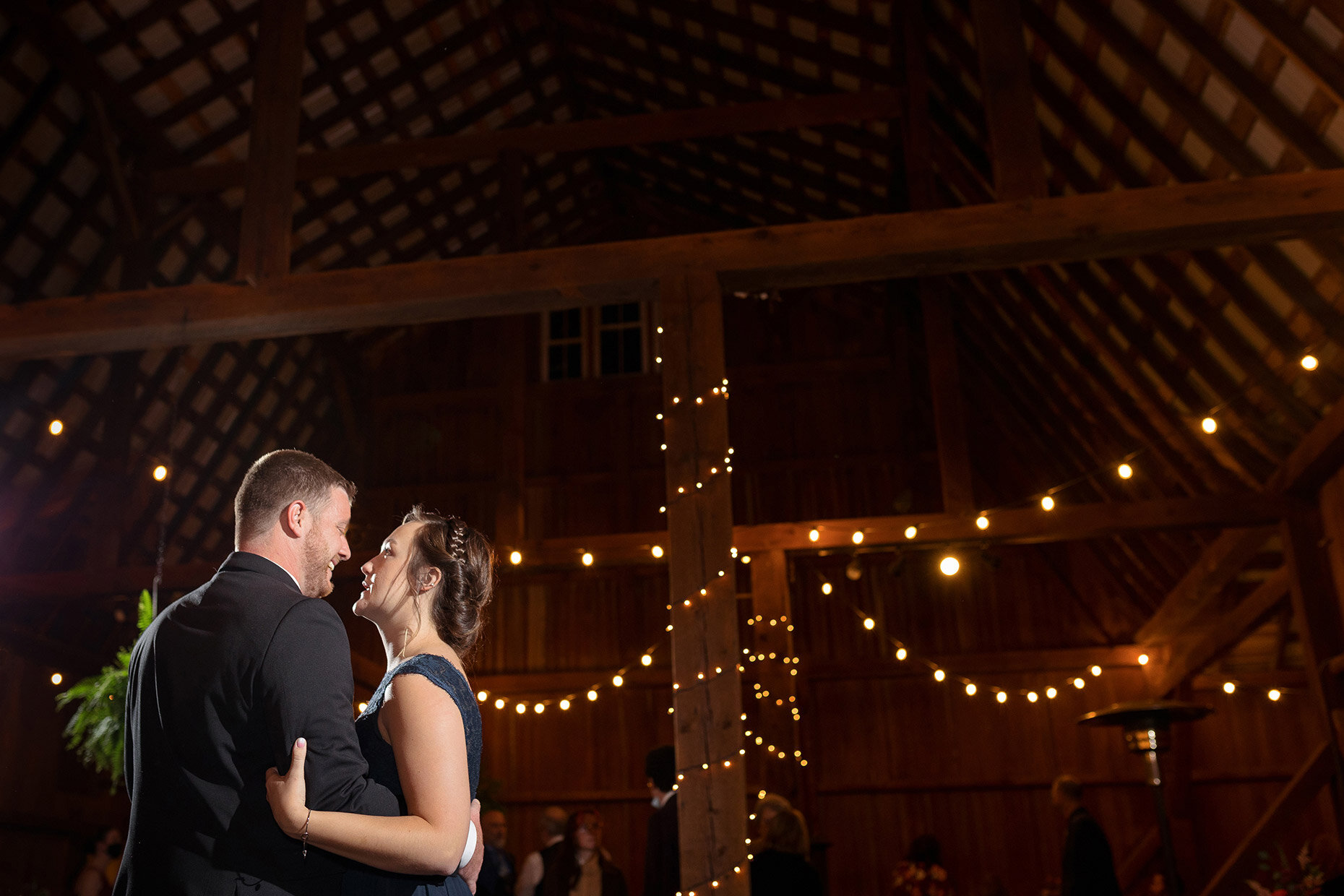 Couple dances at barn reception 