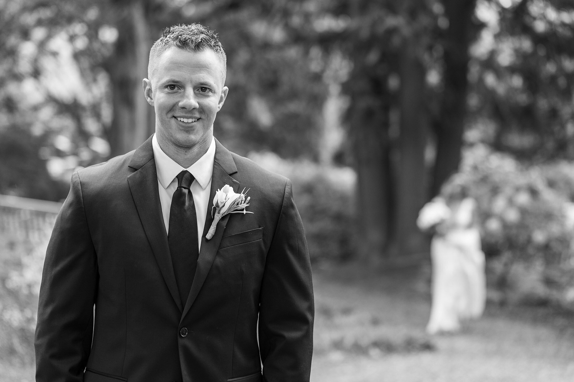 First look in black and white, close up of groom