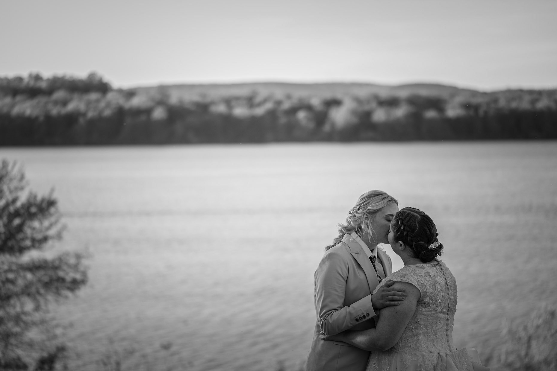 Black and white lakefront kiss