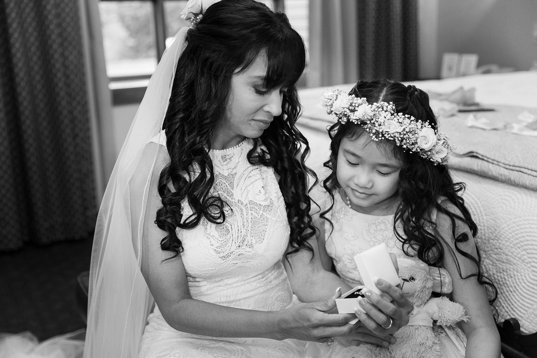 Bride opening gift with daughter