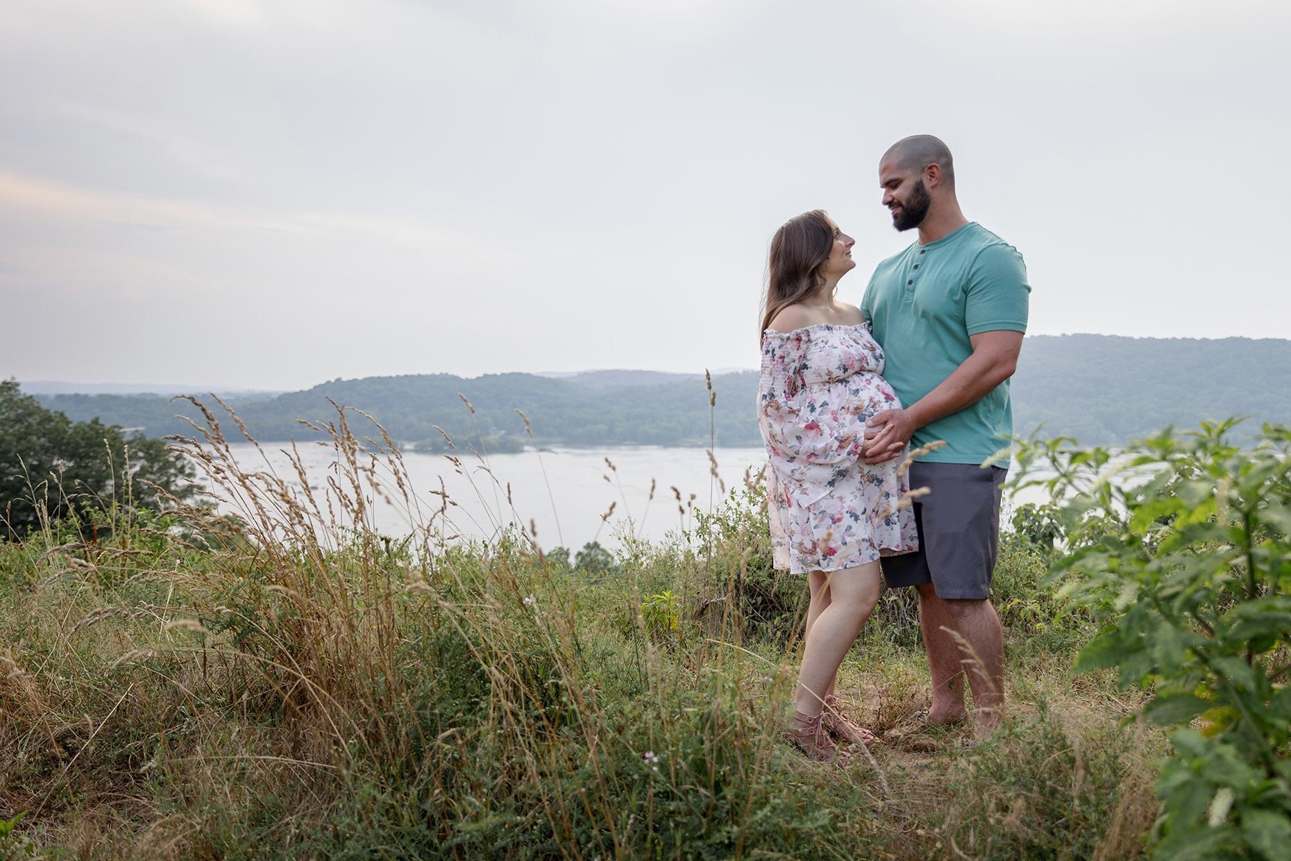 Maternity couple by River in grass overlook