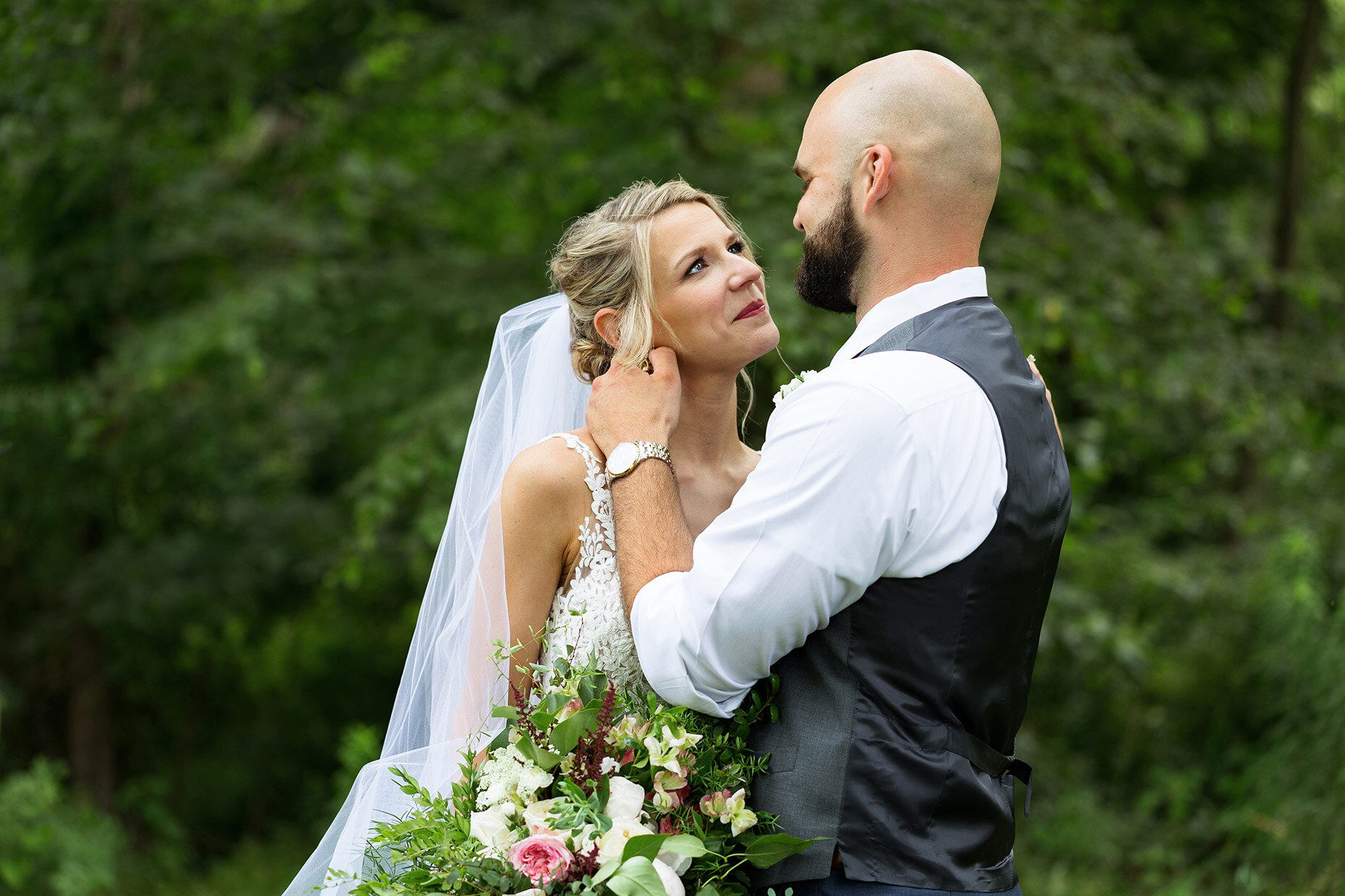 Bride looks into groom's eyes at first look 