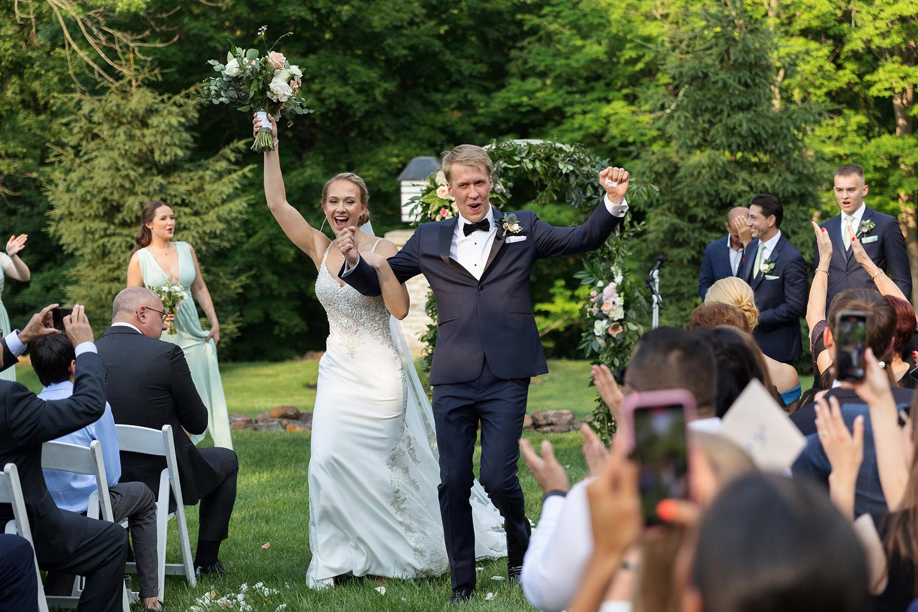 Bride and groom walk down the aisle during recessional