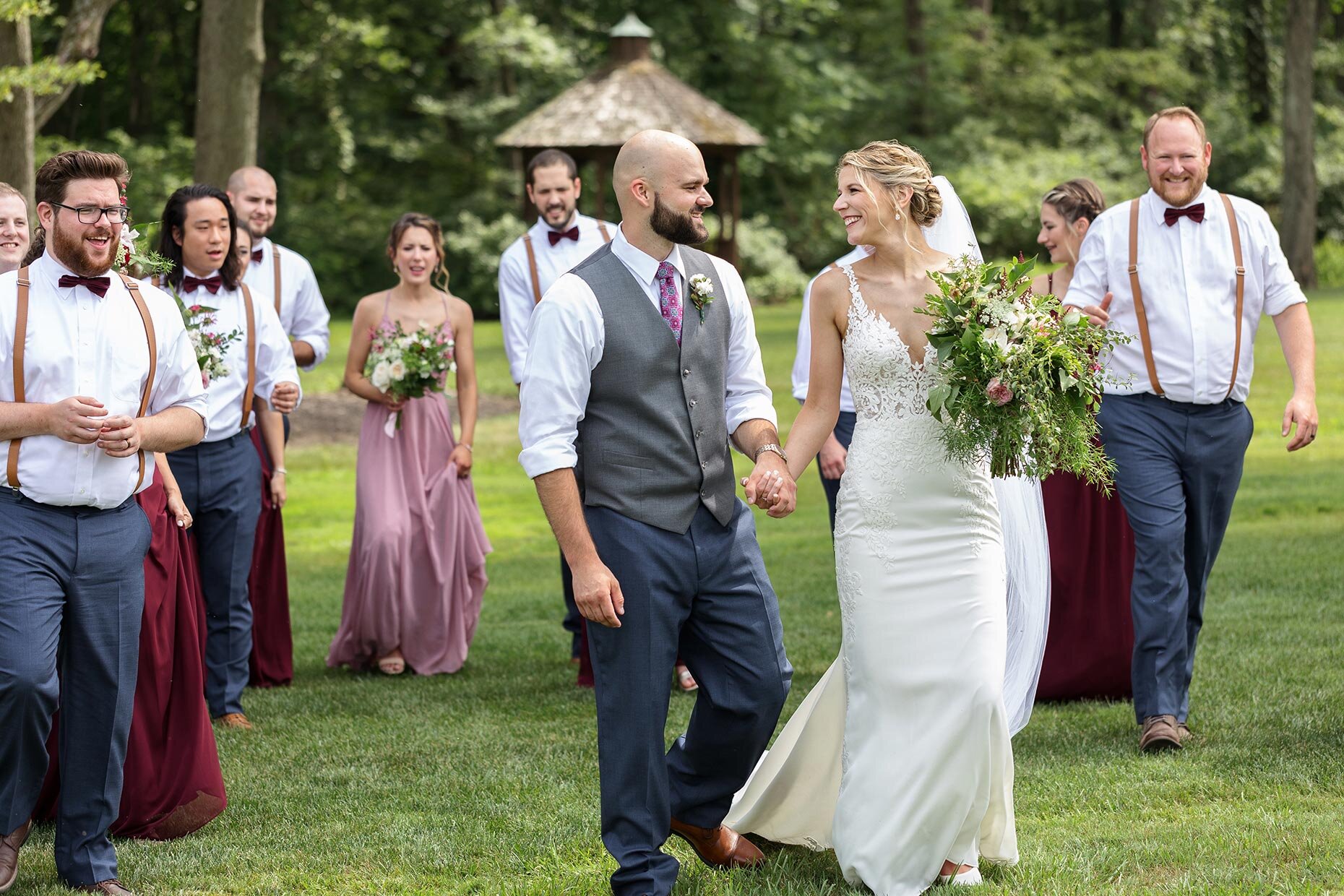Candid of Bride and groom walking with bridal party 