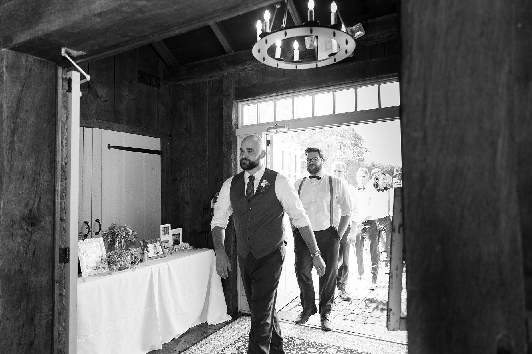 Groom enters barn for his wedding