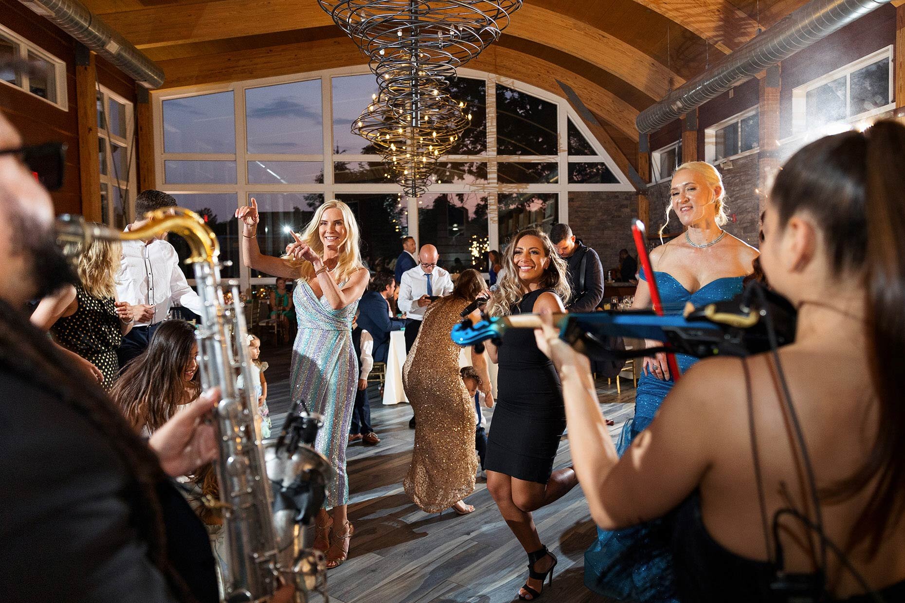 Guests dance with band at reception - saxaphone