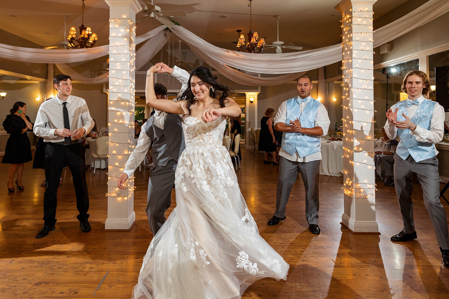 Bride and groom twirl at reception	