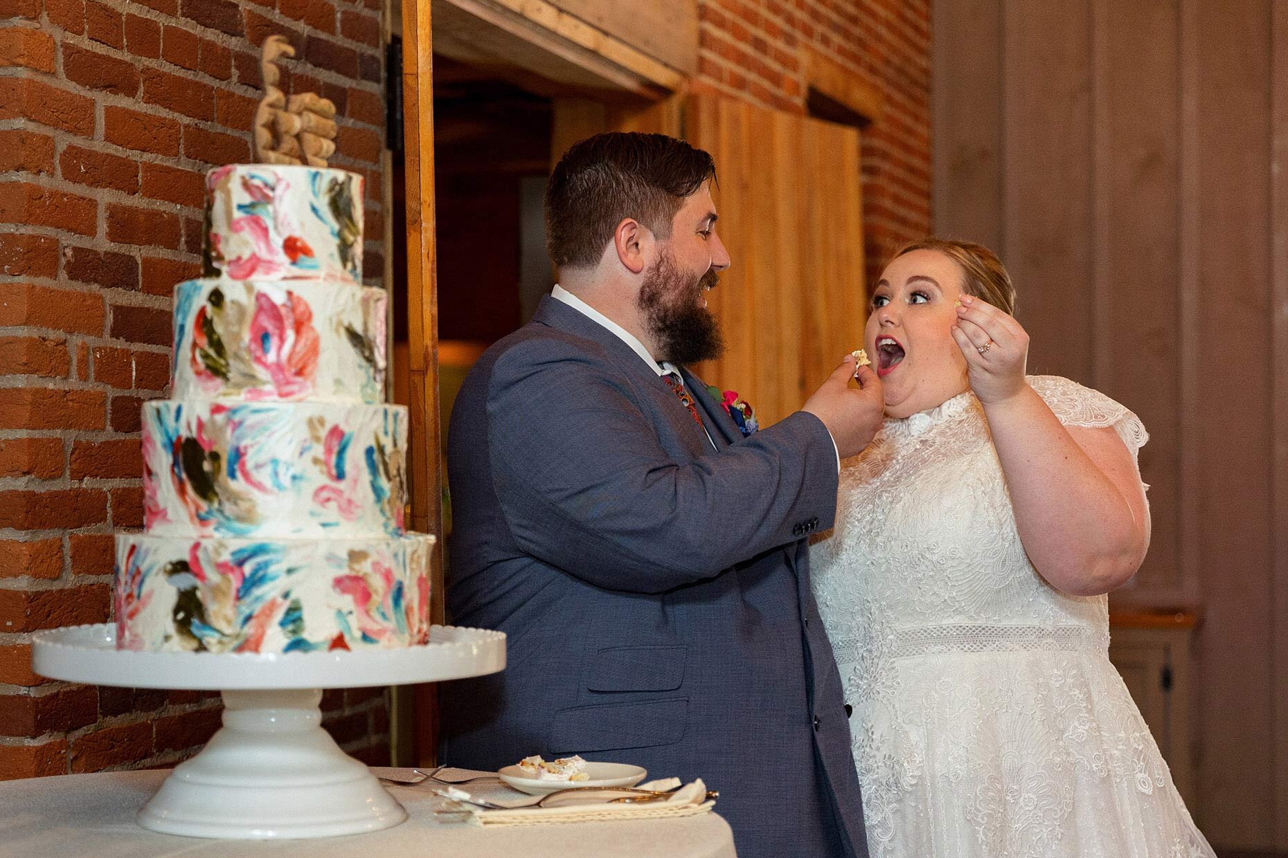 Groom feeding cake to bride