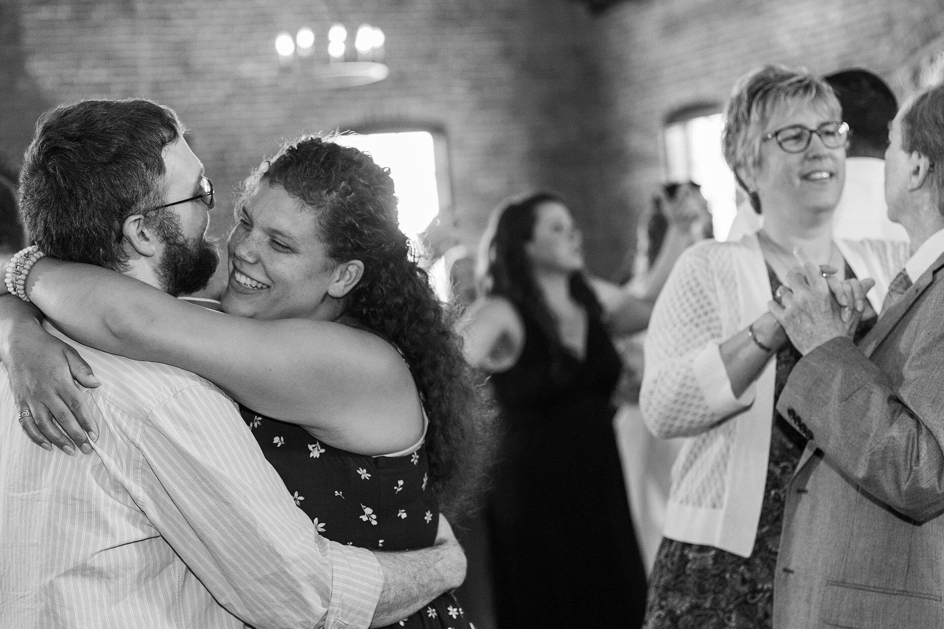 Slow dance couples in black and white at reception