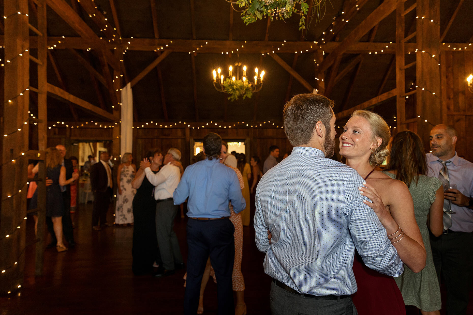Guests Slow Dance at Reception in Barn 
