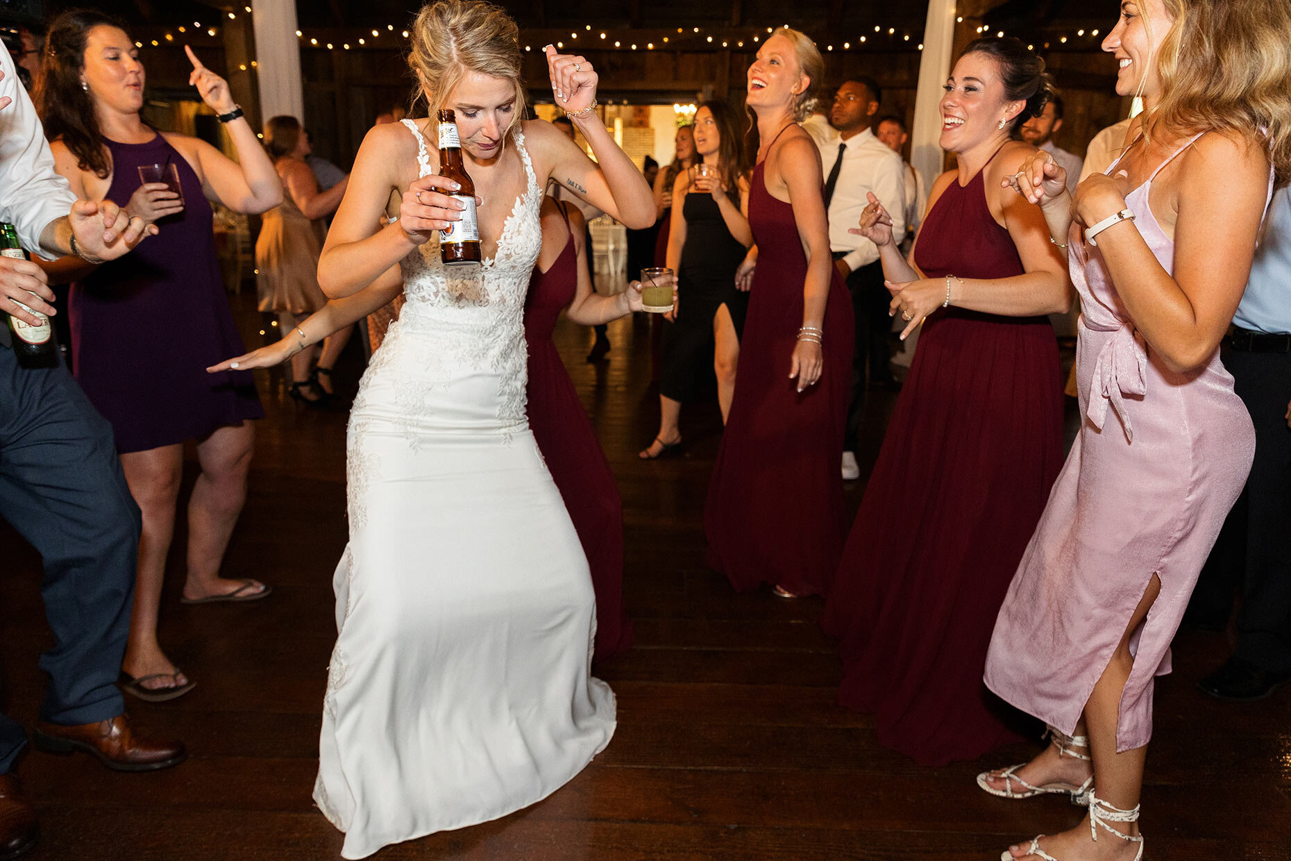 Bride dances with bridesmaids at reception 