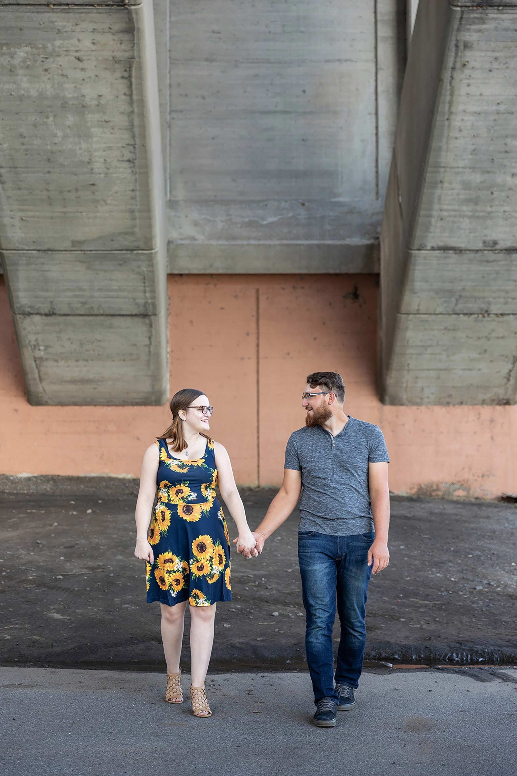 Couple walking under a bridge