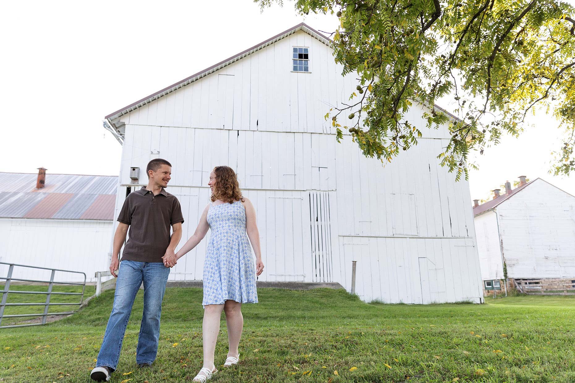 Walking in front of a white barn Engaged