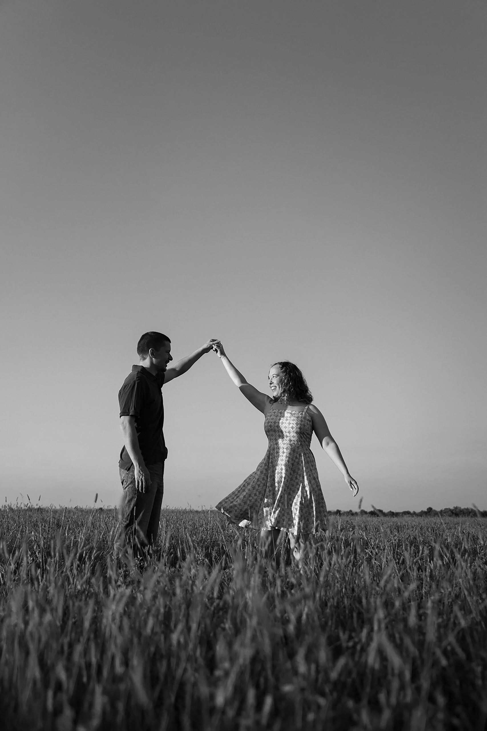 Dancing in a field engagement photo 