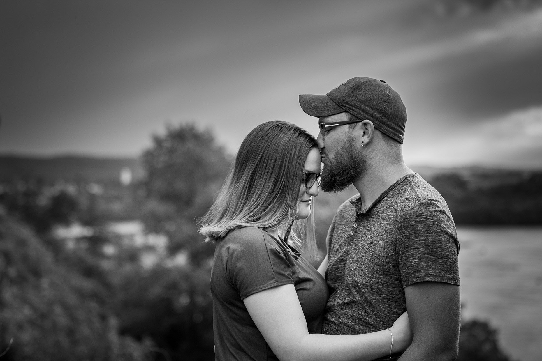 Couple kissing forehead at engagement session 