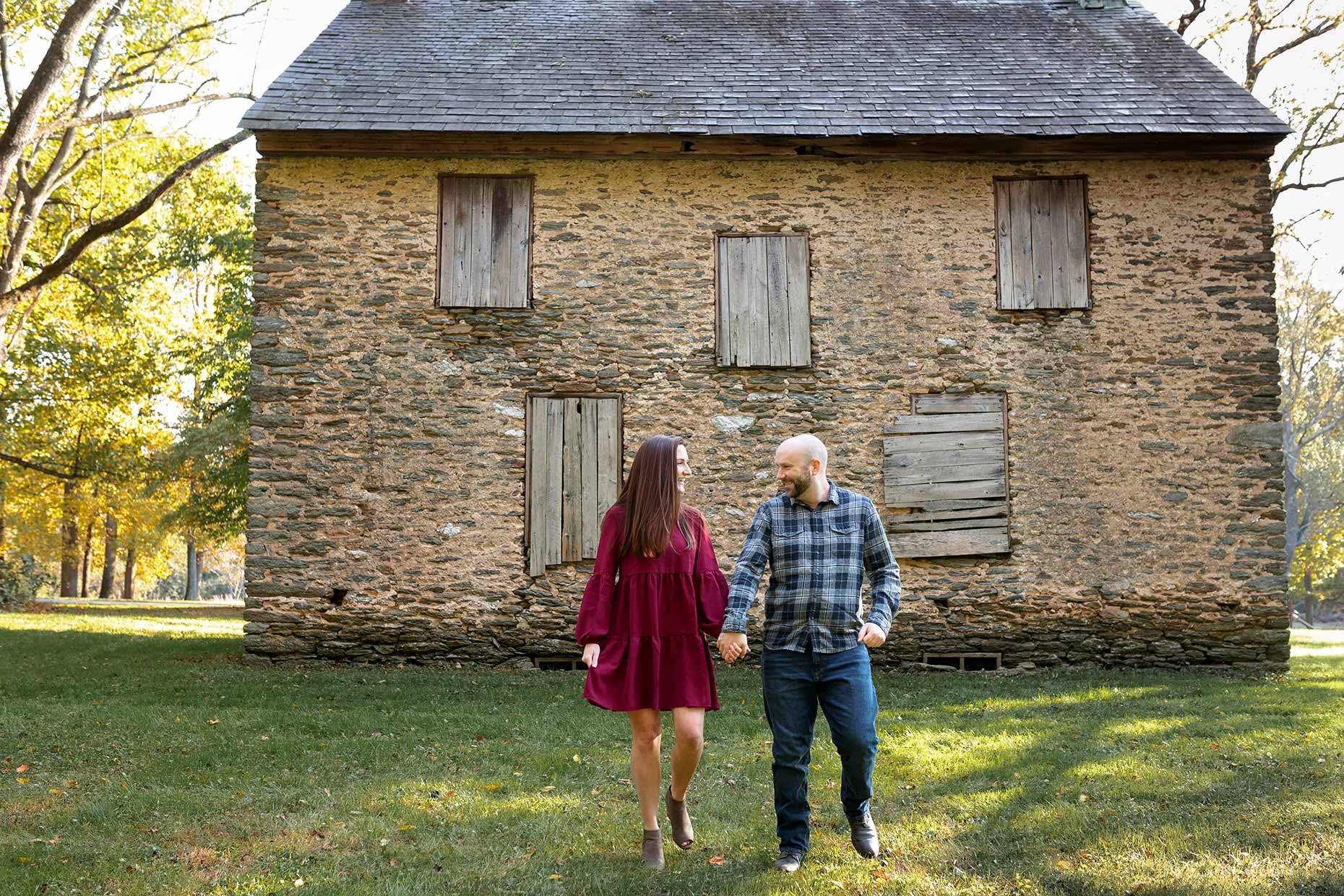 Couple walking in front of James B. Long House 