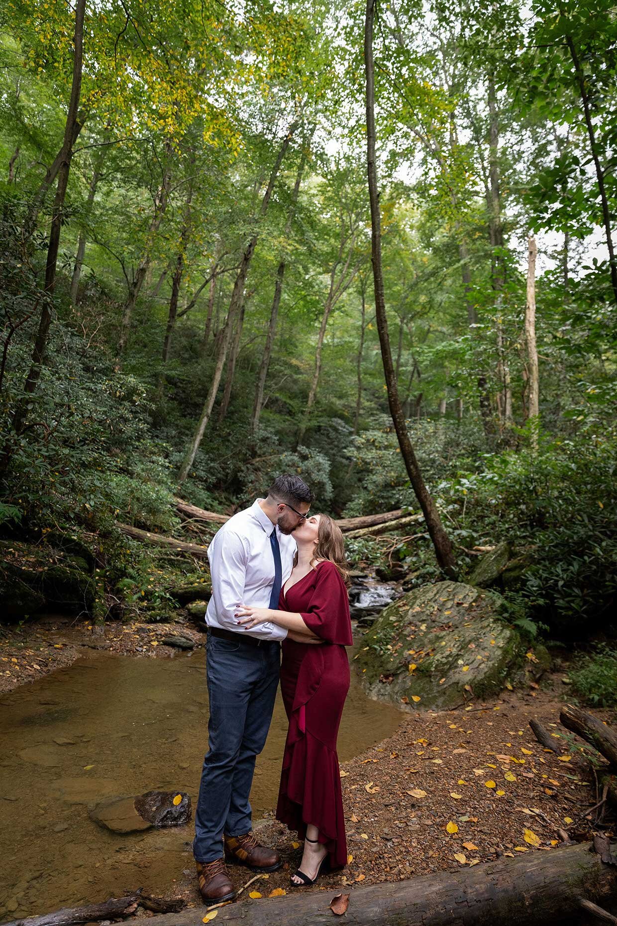 Engagement Photo kissing at creek in the woods