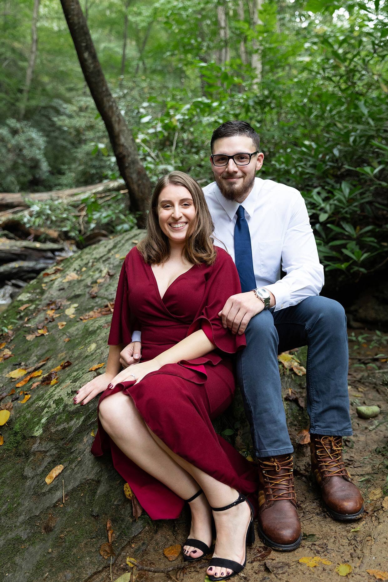Couple sitting on a rock for engagement photos