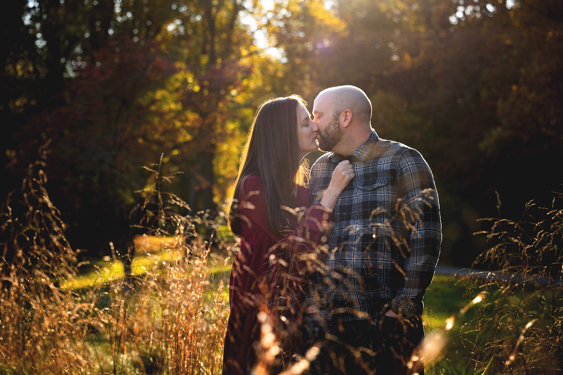Couple kissing in grassy field
