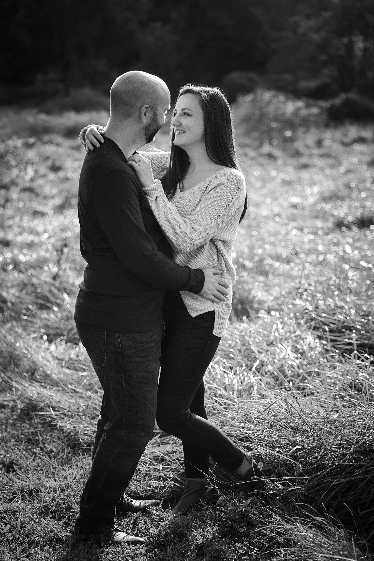 Engagement photo in black in white in field 