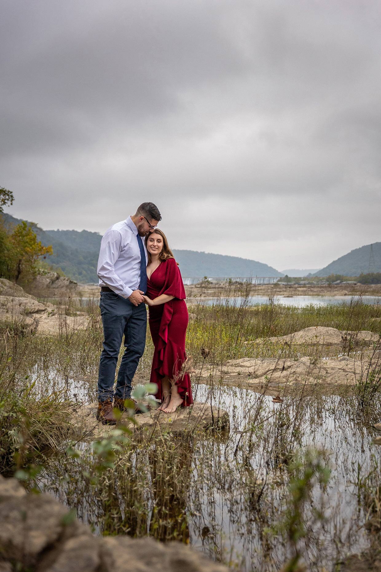 Couple kissing forehead on Susquehanna River 