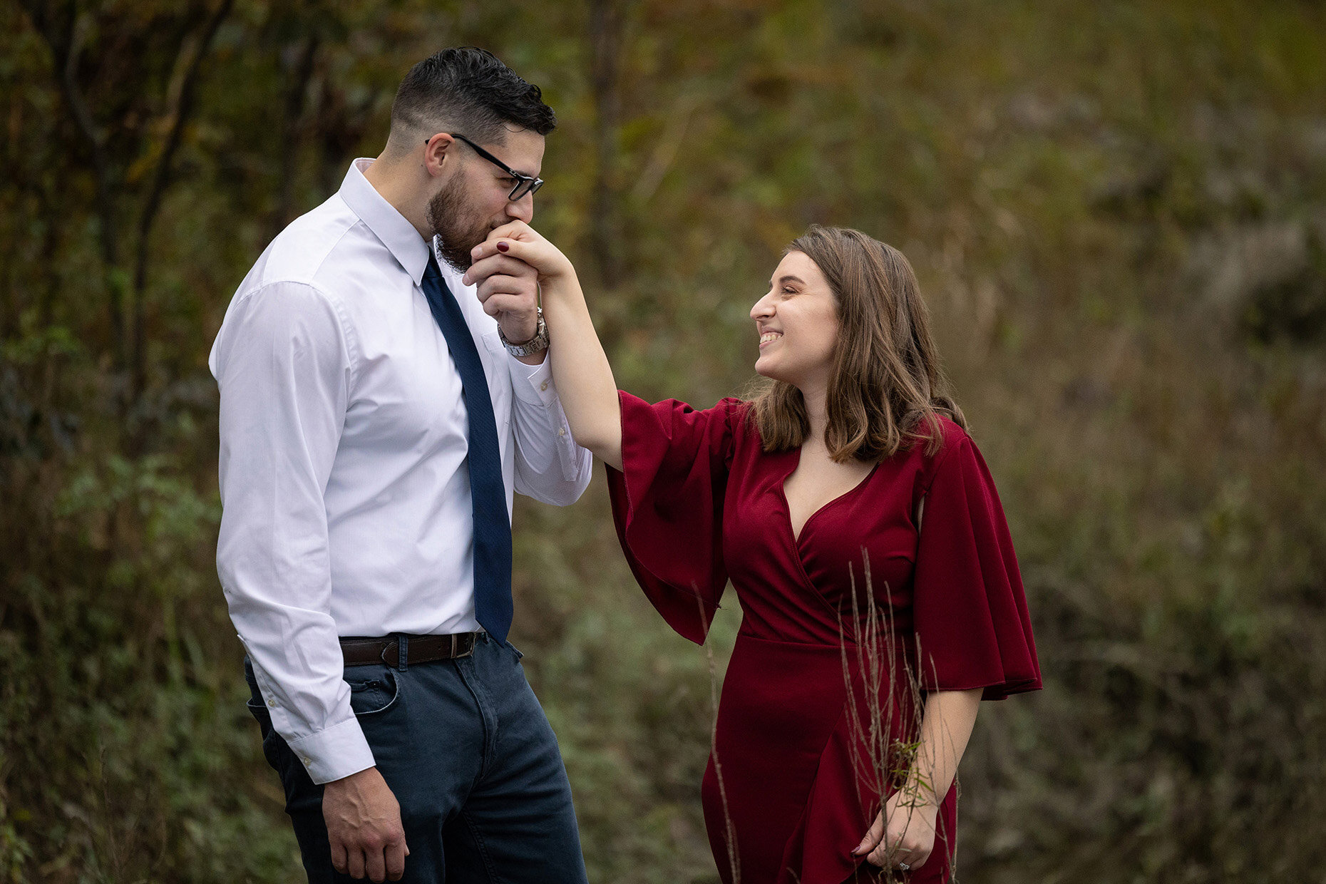 Fiancé kissing hand at engagement session