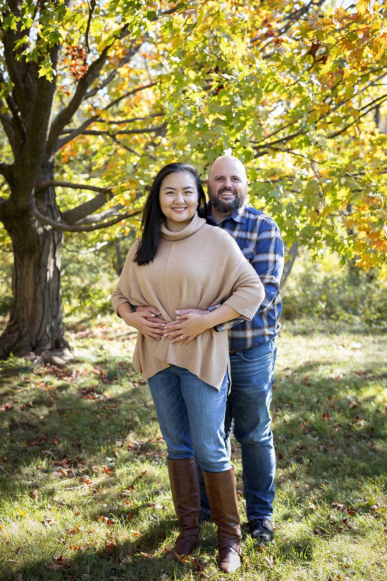 Engaged couple under a golden yellow tree at Cylburn Arboretum