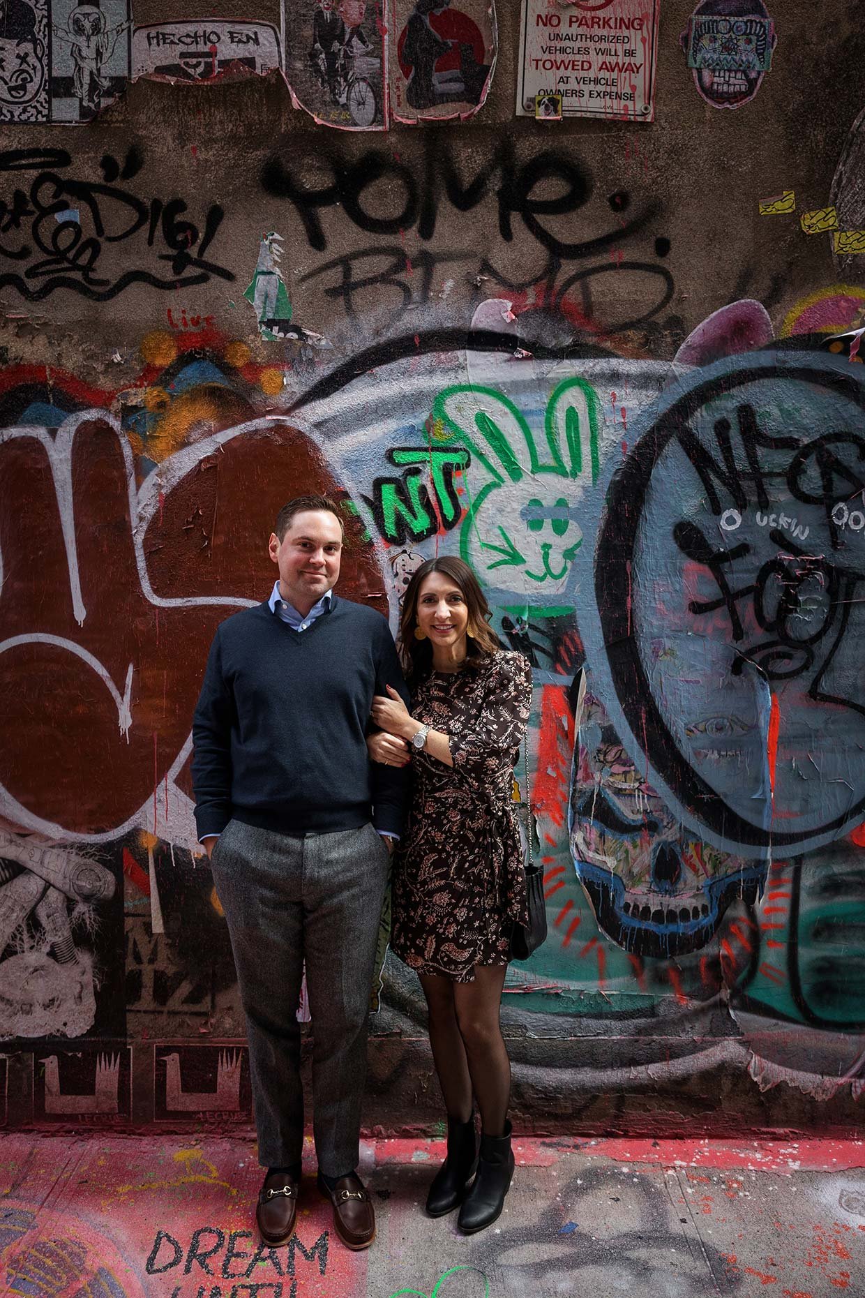 Casual Photo from Engagement Session in front of graffiti wall
