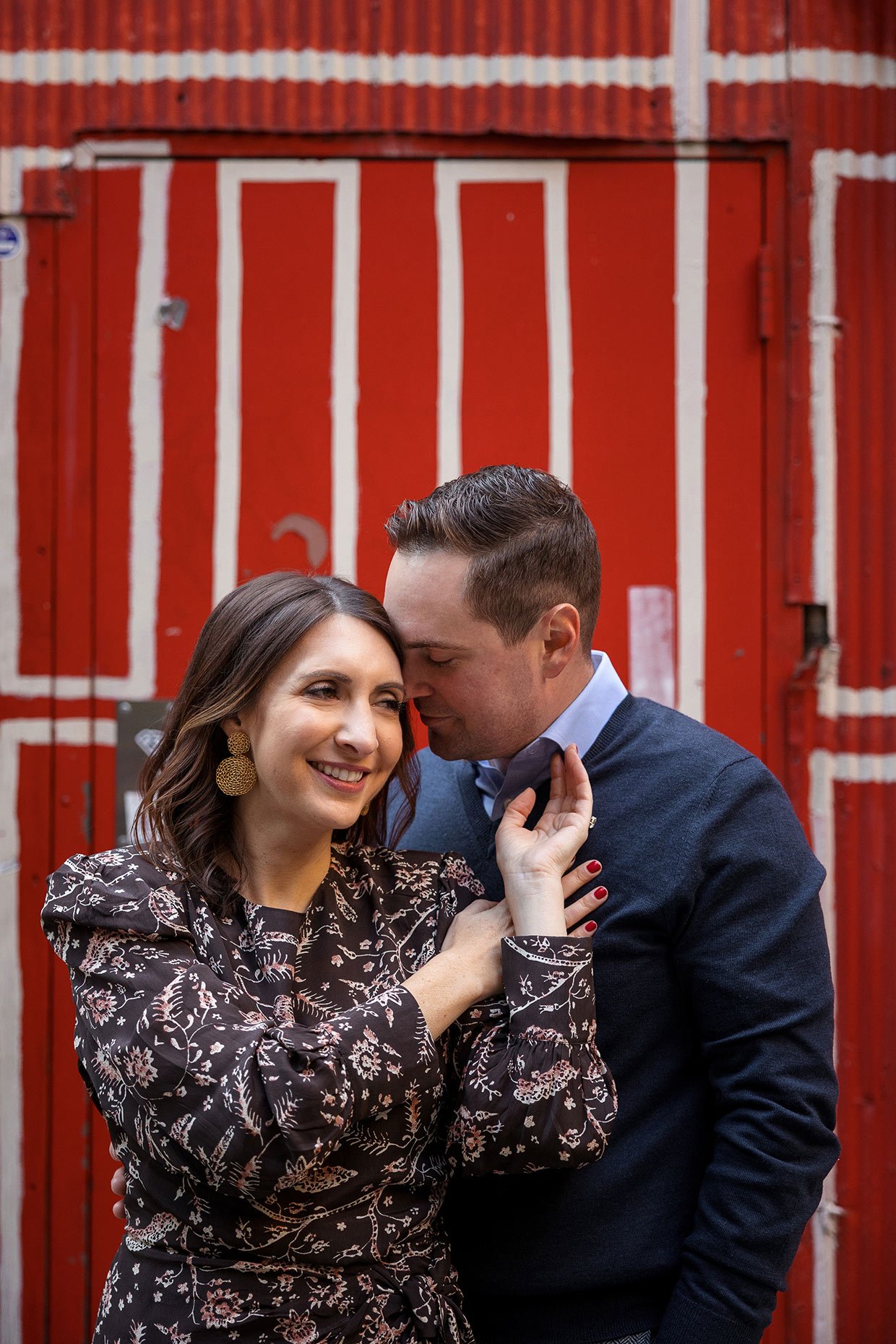 Engagement photo at Freeman's Alley in front of the red door