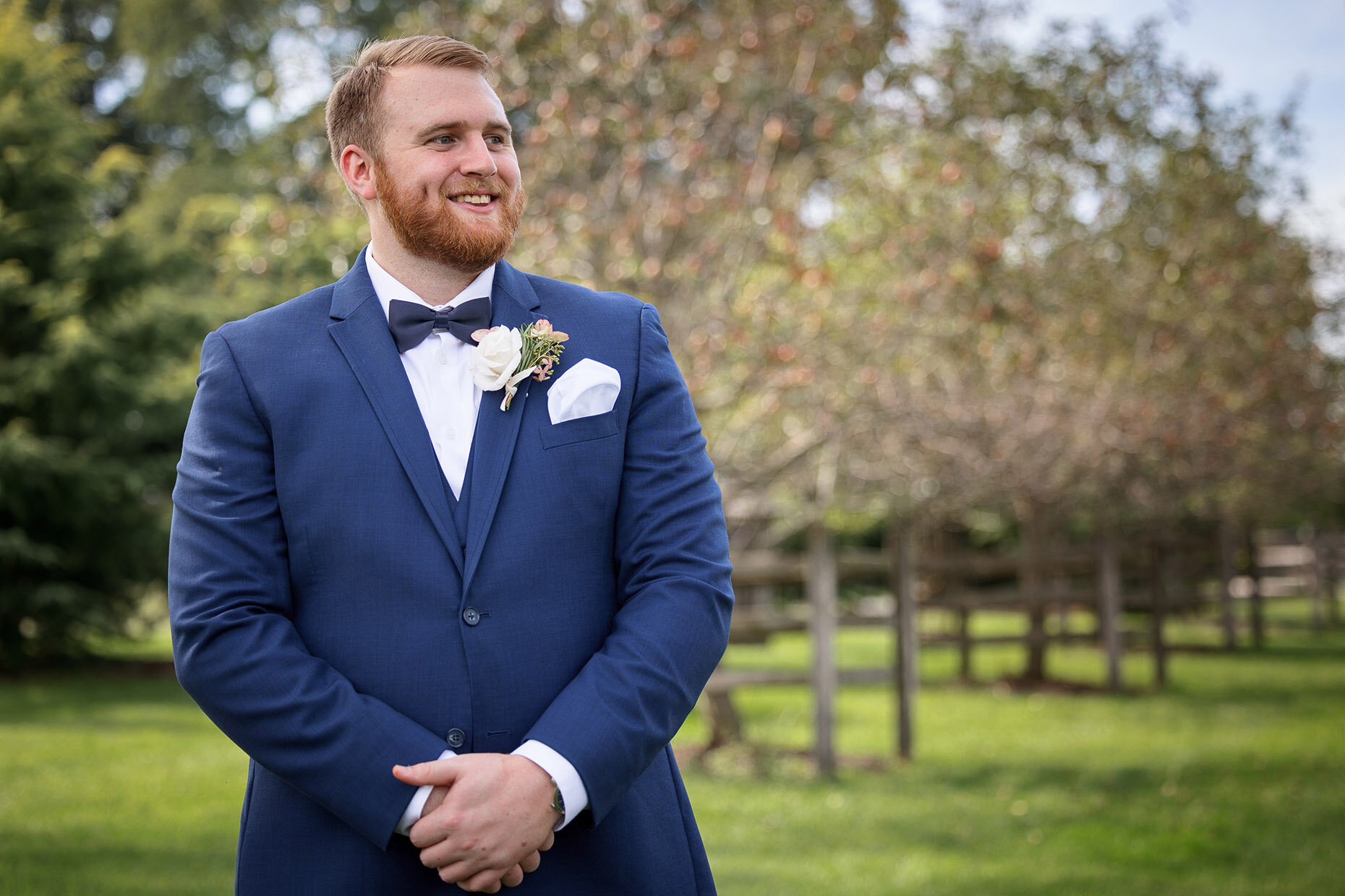 Groom waiting for First Look in Apple Orchard