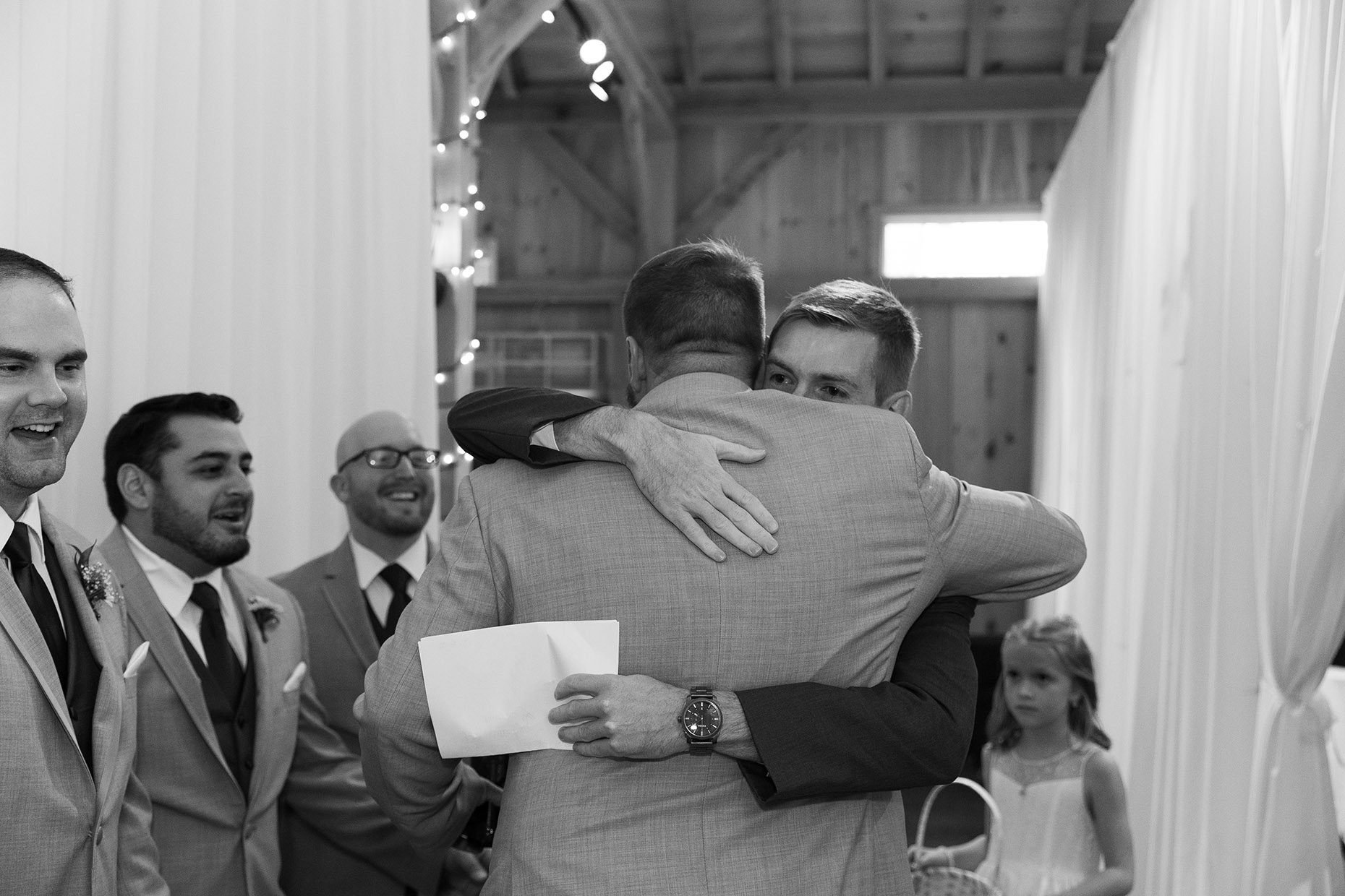 Groom Hugging Groomsmen with vows