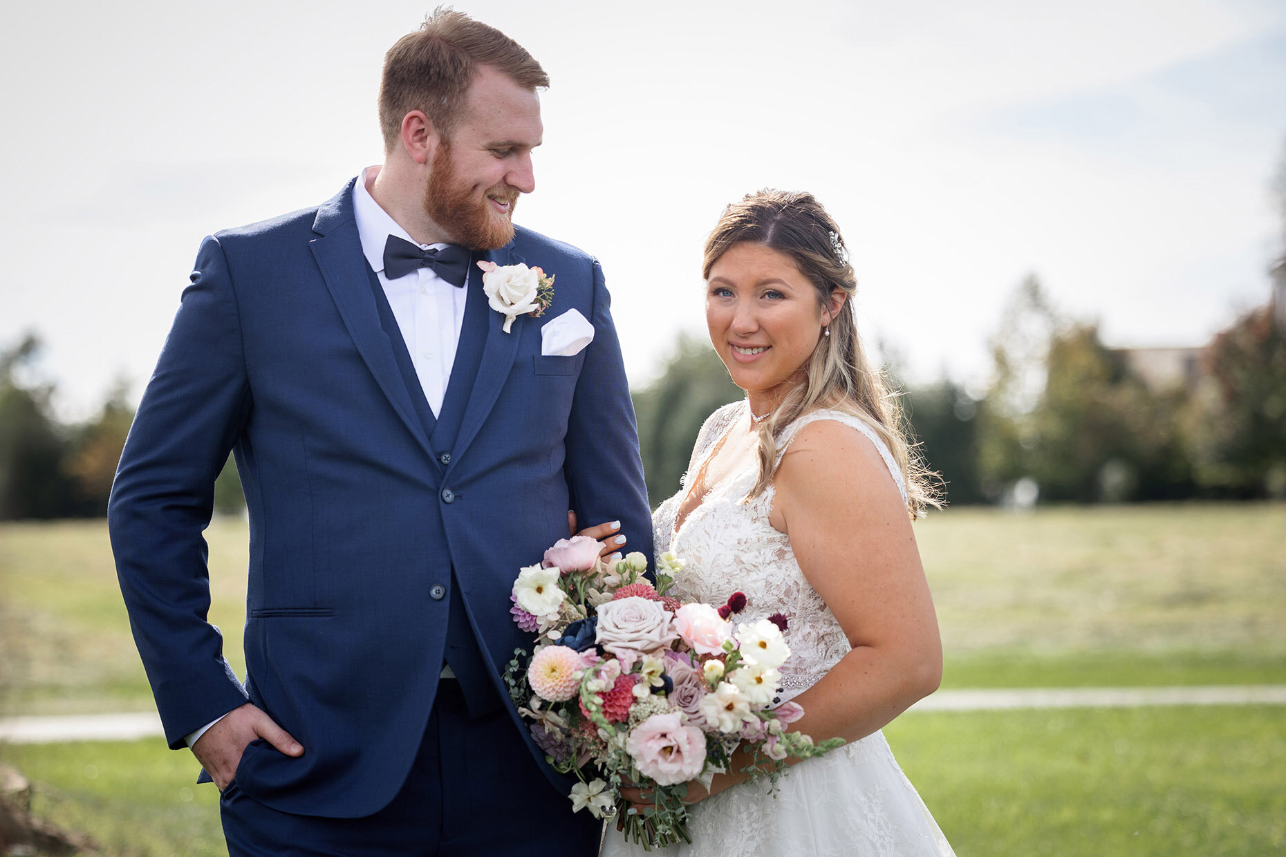Candid Portrait of Bride and Groom in Field