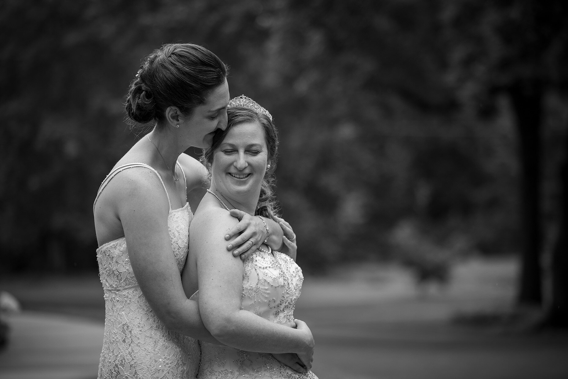 Black and white photo of couple snuggling at wedding
