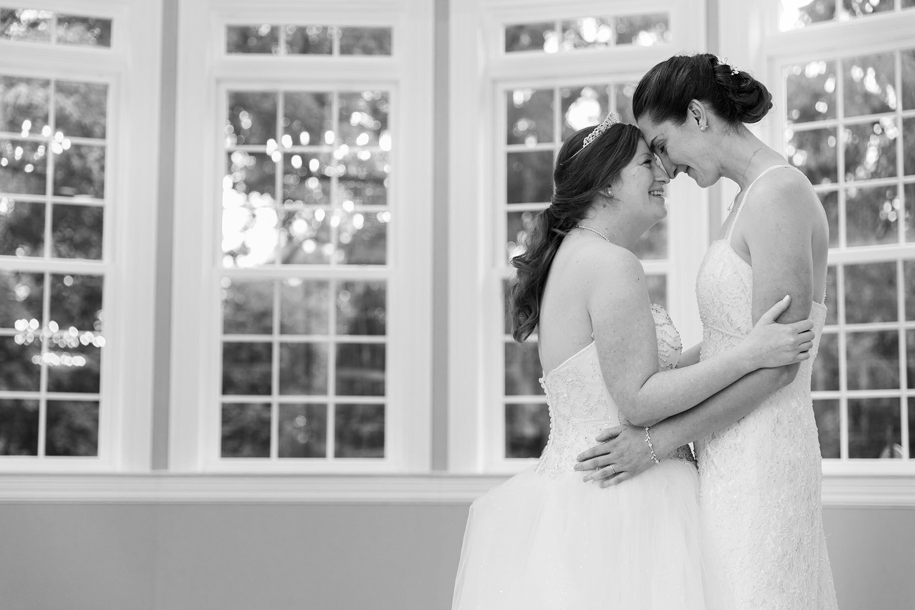 Black and white dancing photo at reception in front of windows
