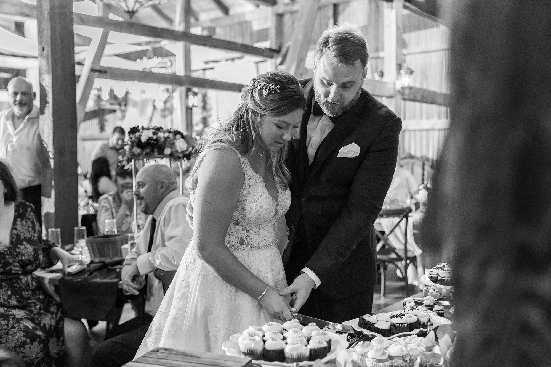 Couple Cutting Cupcakes at wedding