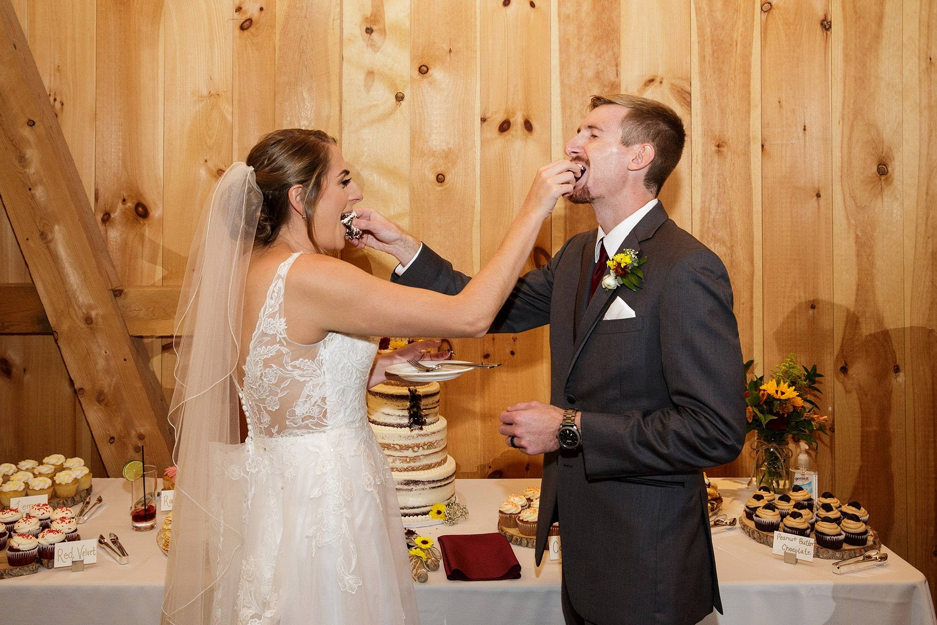 Bride &amp; Groom feed each other cake