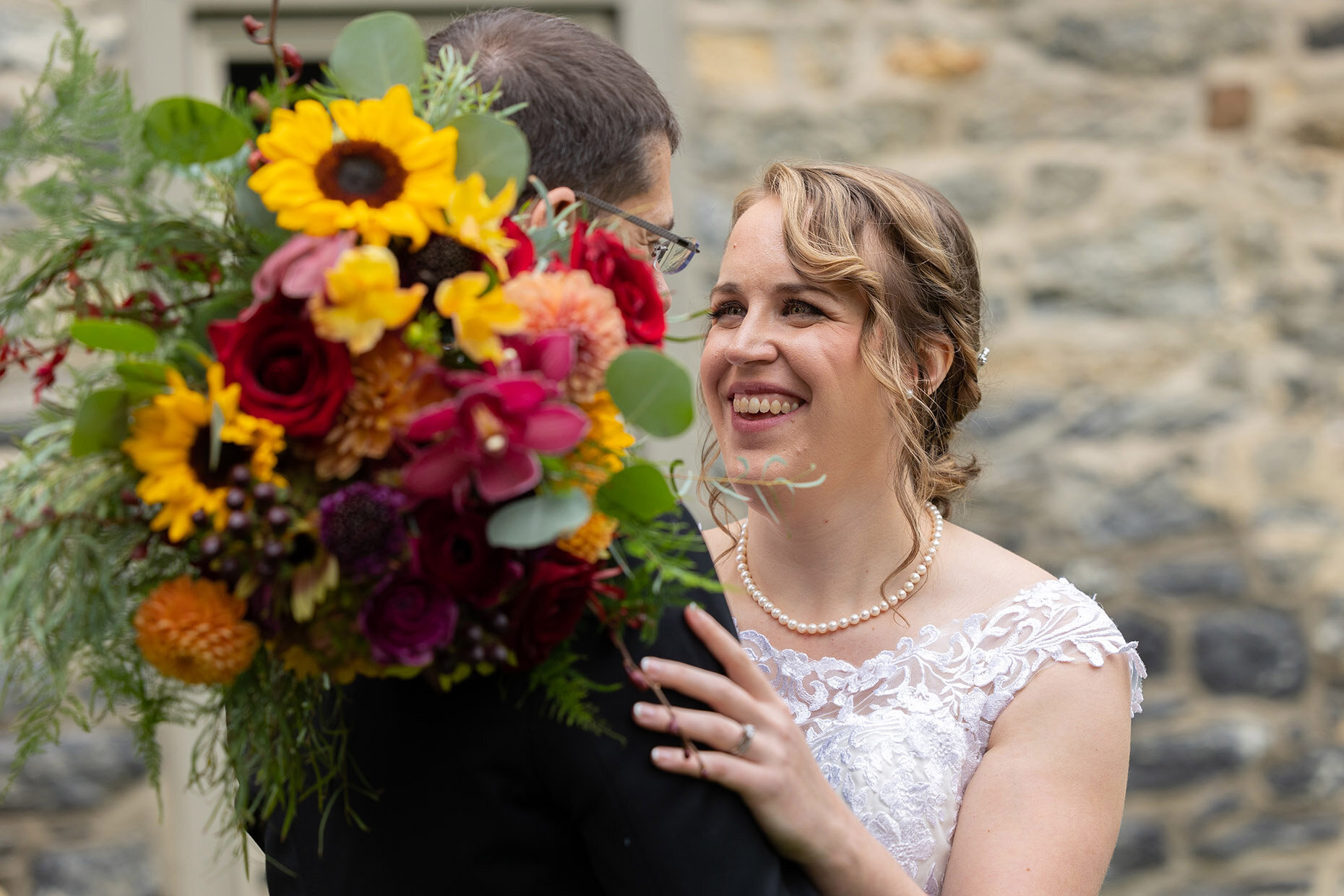 Bride smiling at groom during candid photo 