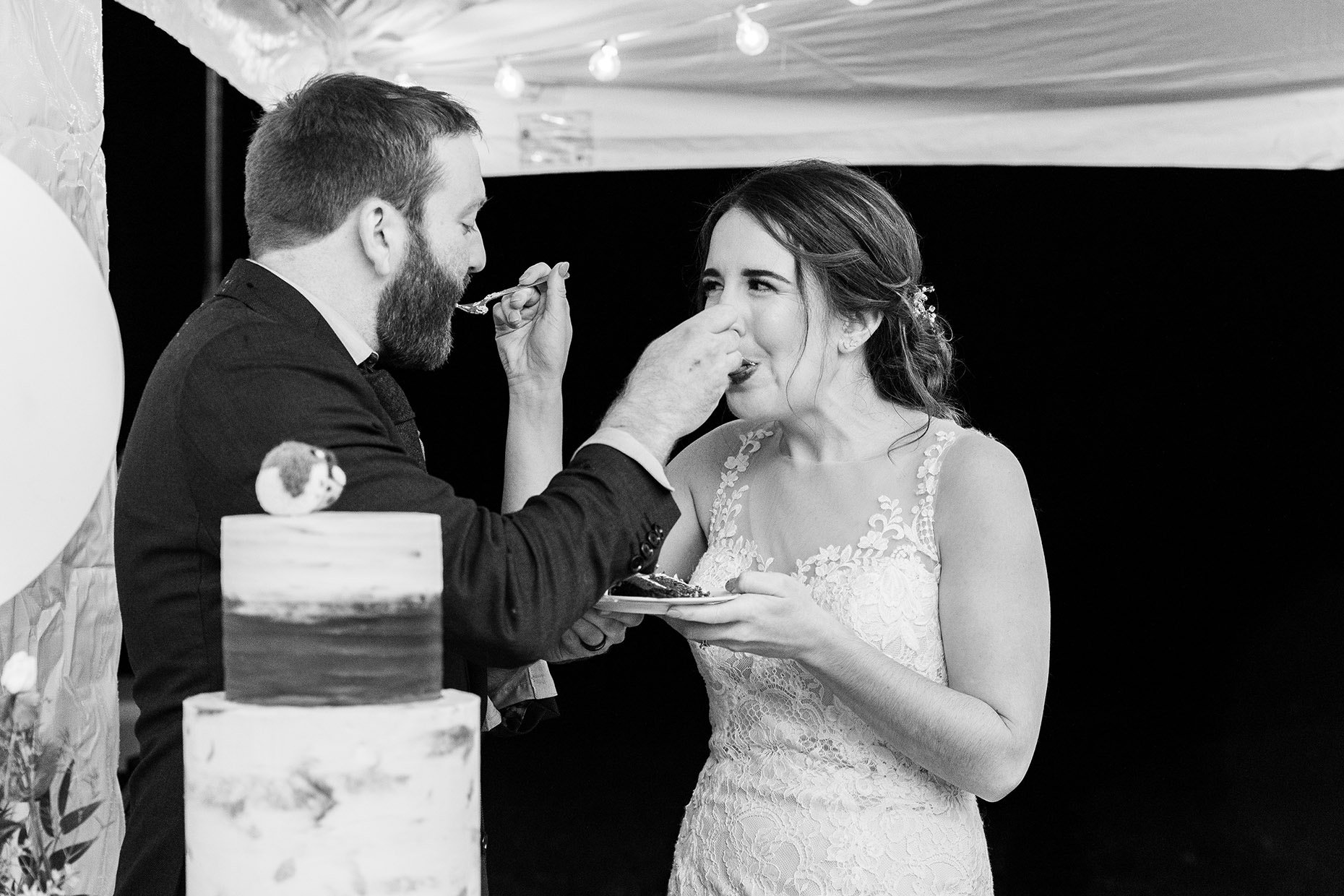 Bride and Groom feed each other Cake 