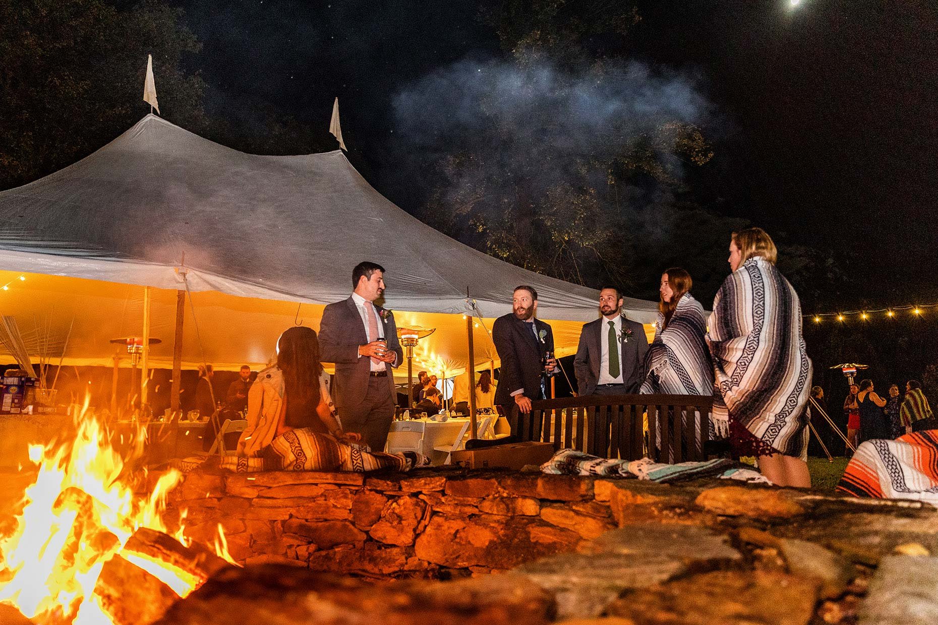 Groom at Fire pit at Wedding Reception 