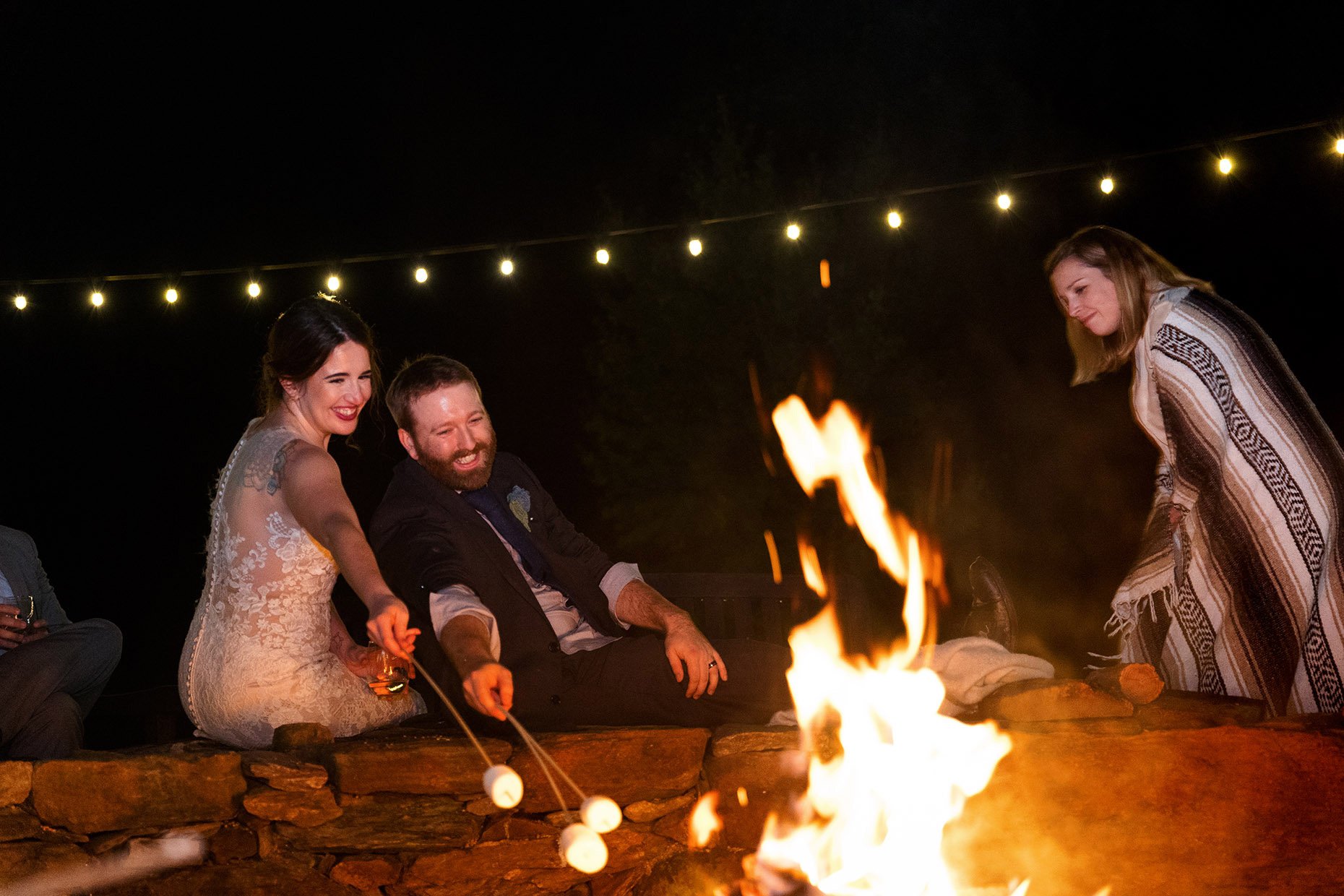 Bride and Groom Roasting Marshmallows at Reception 
