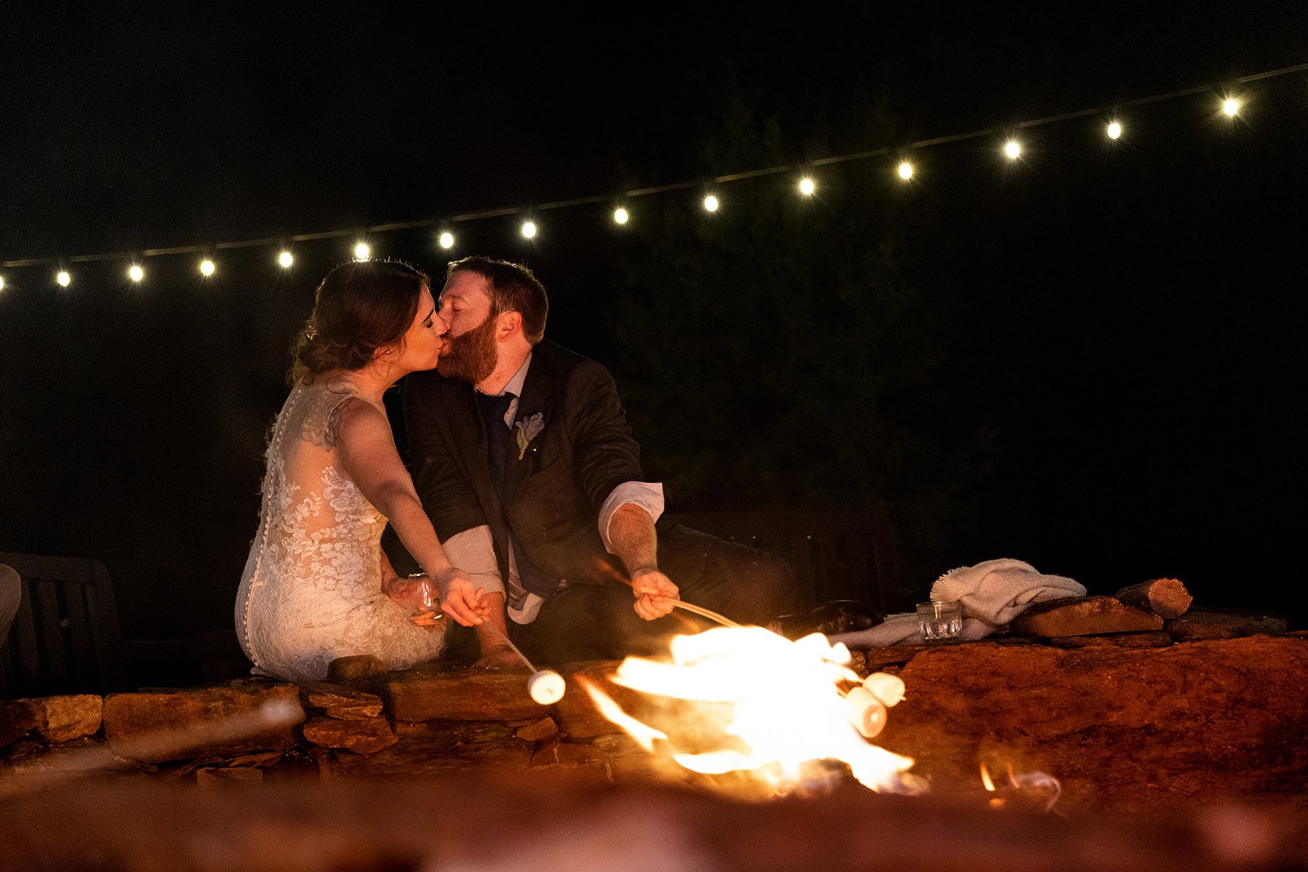 Bride and Groom Kissing Fireside