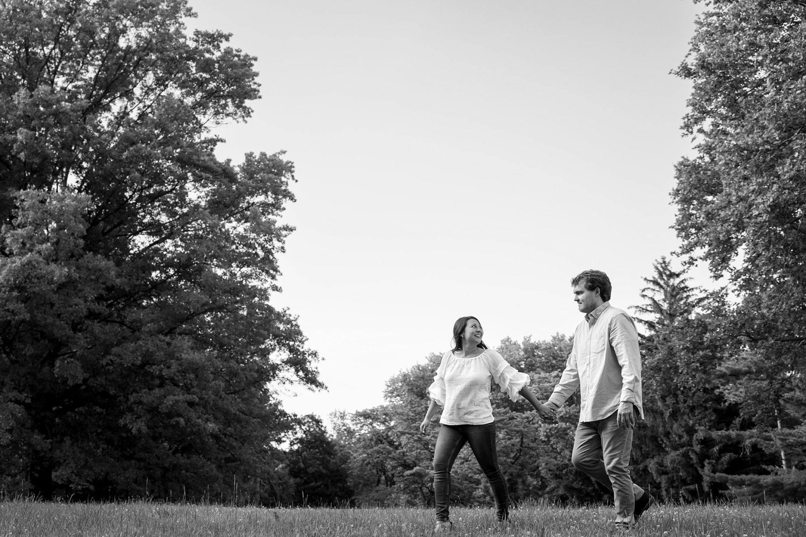 Couple walking in a field at the park